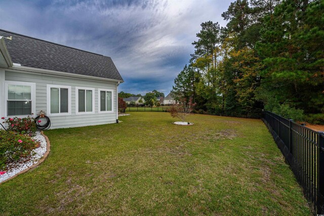 back of house featuring a patio area, a yard, and an outdoor fire pit