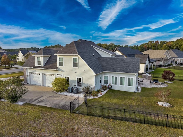 view of front facade with cooling unit, a garage, and a front lawn