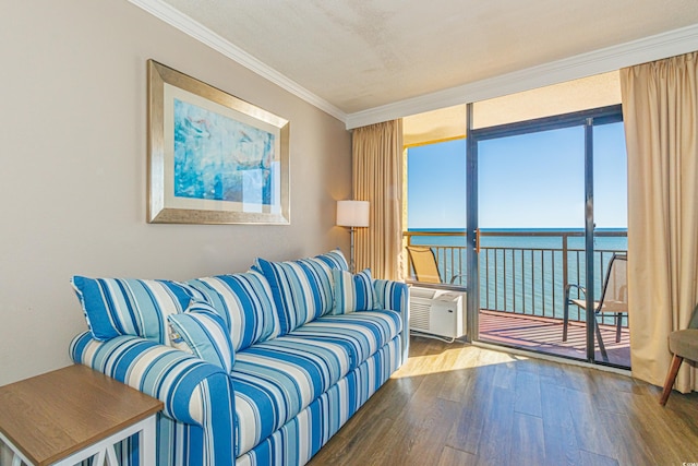 living room with hardwood / wood-style floors, a water view, a wall mounted AC, and crown molding