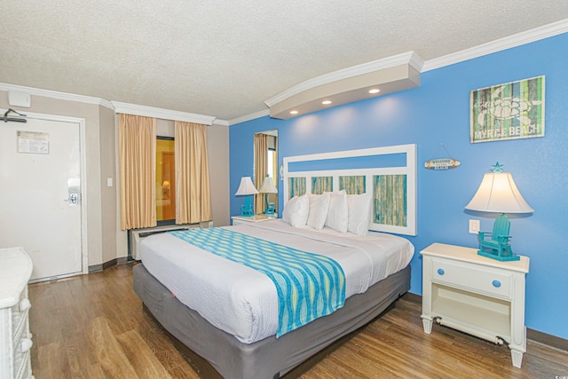 bedroom featuring a textured ceiling, wood-type flooring, and crown molding