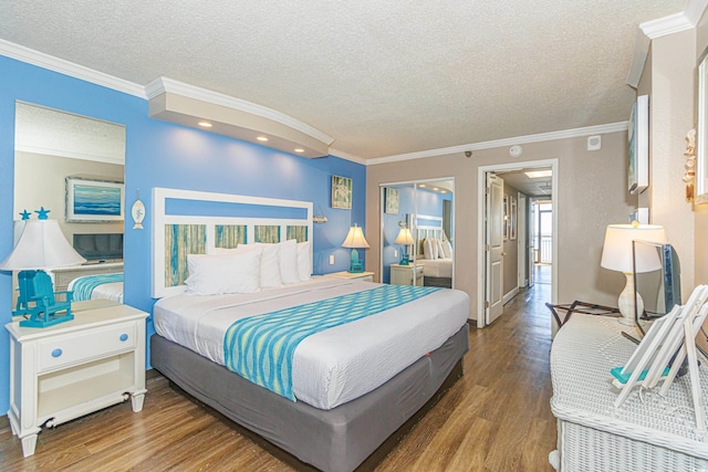 bedroom with ornamental molding, a textured ceiling, and hardwood / wood-style flooring