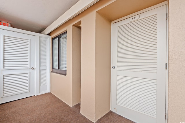 corridor with carpet flooring