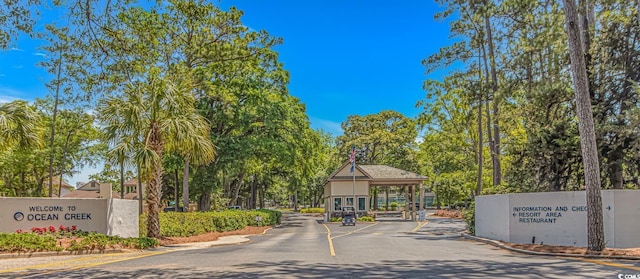 100 Ocean Creek Dr Unit L5, Myrtle Beach, SC 29572 - view of asphalt road with a gated entry and curbs