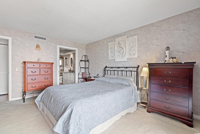 carpeted bedroom featuring visible vents and connected bathroom