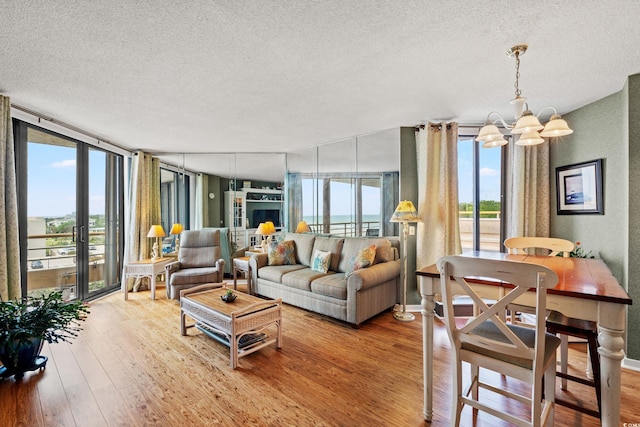 100 Ocean Creek Dr Unit L5, Myrtle Beach, SC 29572 - living area featuring a textured ceiling, a chandelier, and wood-type flooring