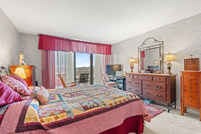 carpeted bedroom featuring access to exterior and a textured ceiling