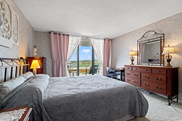 100 Ocean Creek Dr Unit L5, Myrtle Beach, SC 29572 - bedroom featuring a textured ceiling, access to exterior, carpet flooring, and a textured wall