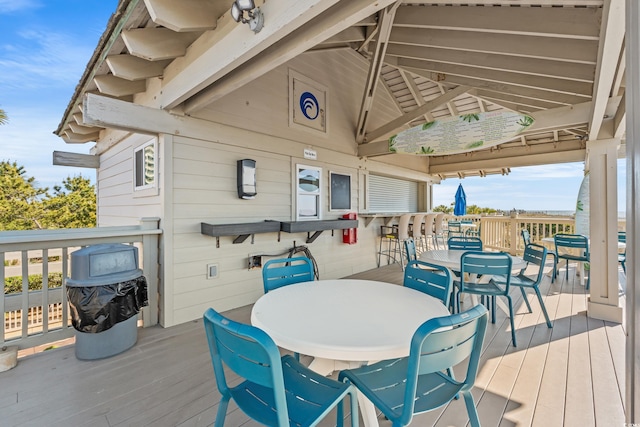 wooden terrace with outdoor dining area