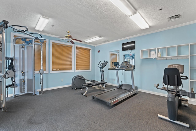 gym with a textured ceiling, ceiling fan, and crown molding