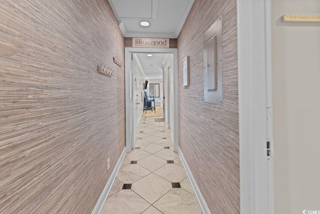 corridor with light tile patterned floors and ornamental molding