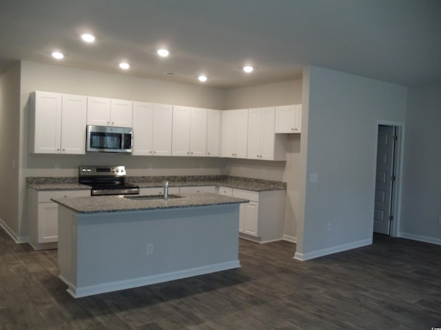 kitchen featuring appliances with stainless steel finishes, a center island with sink, white cabinets, and dark hardwood / wood-style flooring