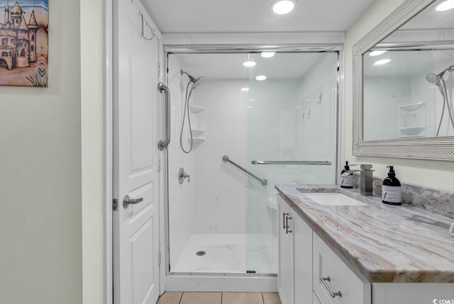 bathroom featuring vanity, tile patterned floors, and an enclosed shower