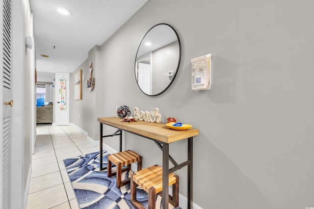 hall featuring light tile patterned floors