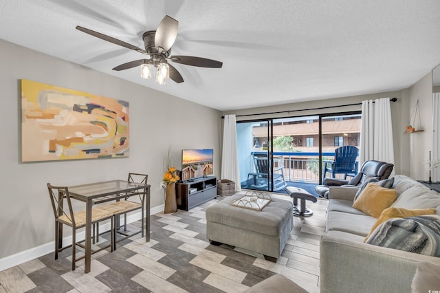 living room featuring a textured ceiling, light hardwood / wood-style flooring, and ceiling fan