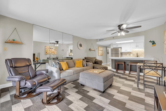 living room with light wood-type flooring and sink