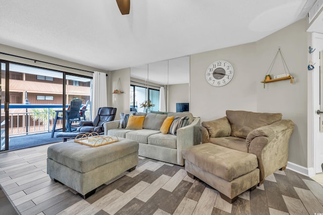 living room with hardwood / wood-style flooring, a wealth of natural light, and ceiling fan