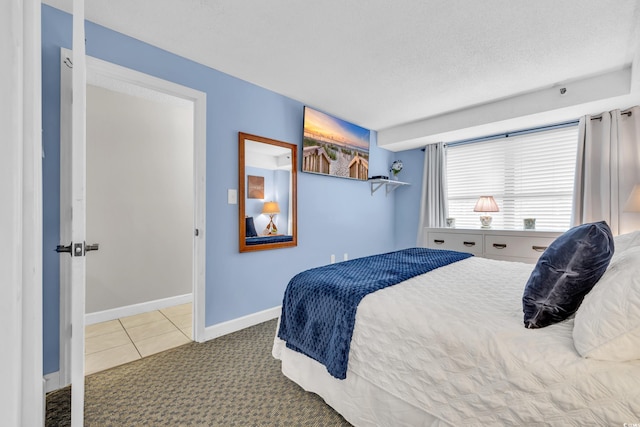 carpeted bedroom featuring a textured ceiling