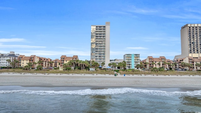 exterior space featuring a water view and a beach view