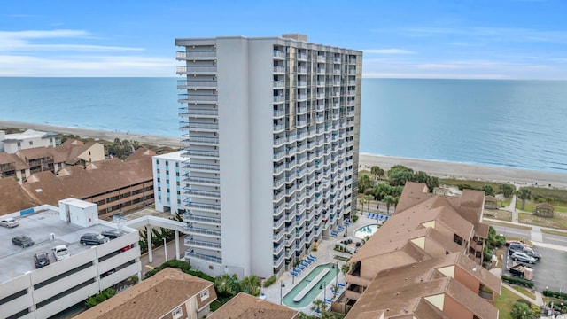 aerial view with a water view and a beach view