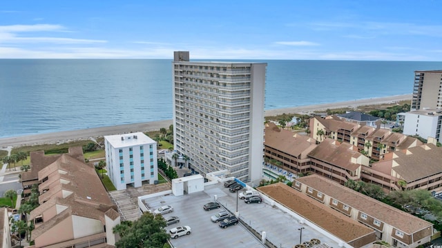 drone / aerial view featuring a water view and a view of the beach