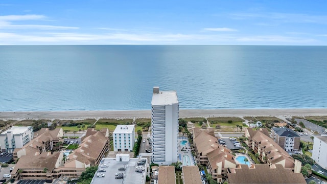 birds eye view of property with a beach view and a water view