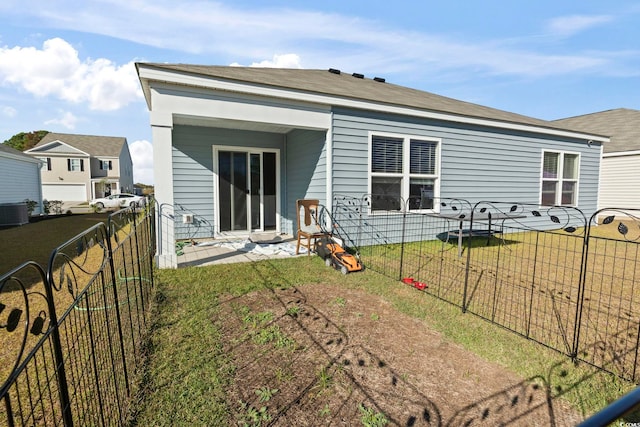 rear view of house with a lawn