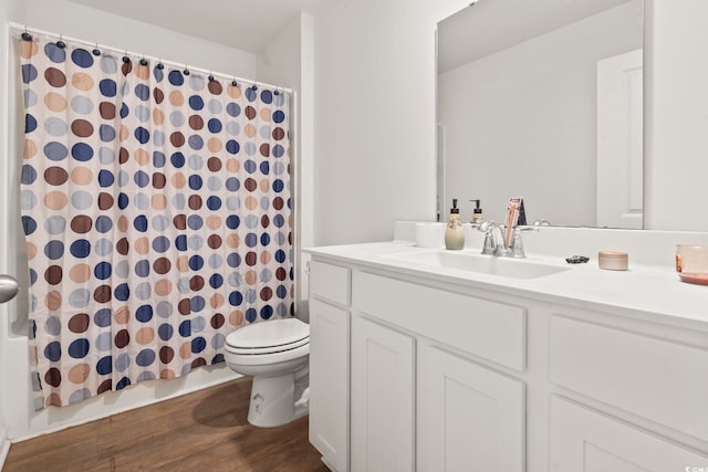 full bathroom with hardwood / wood-style flooring, vanity, toilet, and shower / bath combo with shower curtain