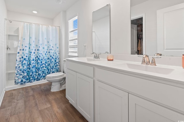 bathroom featuring a shower with shower curtain, vanity, toilet, and wood-type flooring