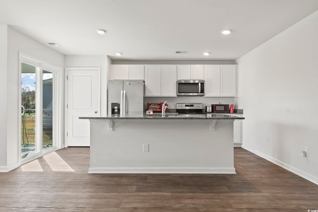 kitchen featuring white cabinetry, an island with sink, and stainless steel appliances