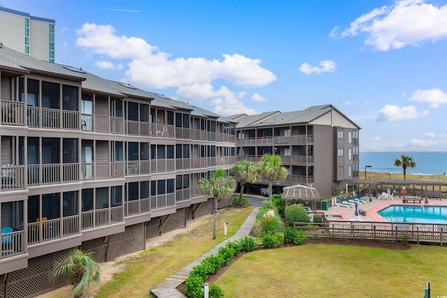 view of property featuring a community pool and a water view