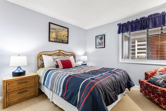 bedroom with a textured ceiling, ornamental molding, and light carpet