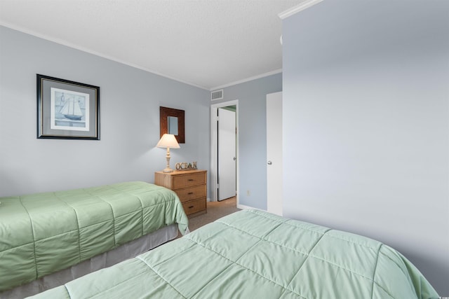 bedroom featuring carpet floors, a textured ceiling, and ornamental molding