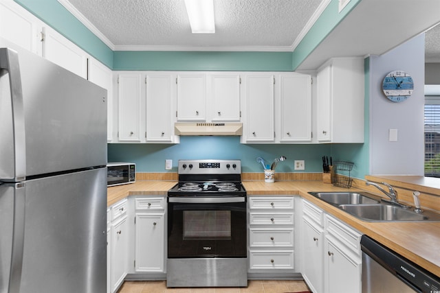 kitchen featuring appliances with stainless steel finishes, a textured ceiling, white cabinetry, and exhaust hood