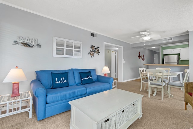 living room featuring a textured ceiling, light colored carpet, and ceiling fan