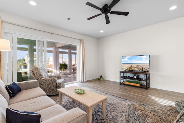 living room with ceiling fan and wood-type flooring