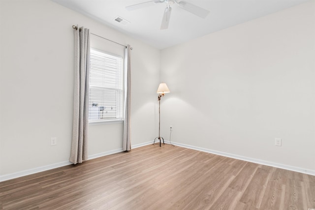 spare room featuring hardwood / wood-style flooring and ceiling fan