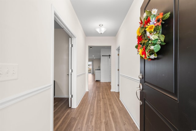 hall with hardwood / wood-style flooring