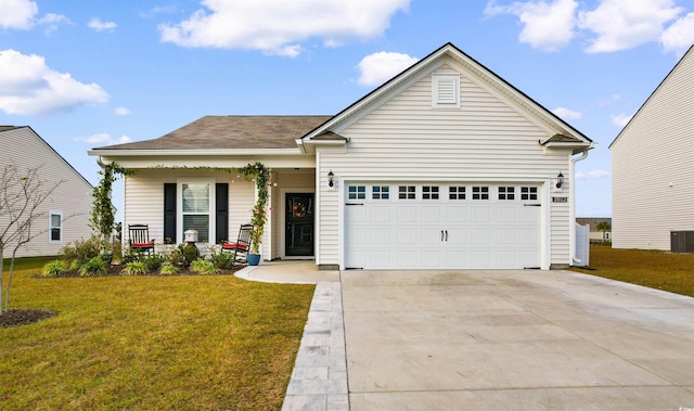 view of front of home with covered porch, a garage, and a front lawn