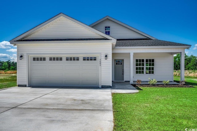 view of front of home featuring an attached garage, a shingled roof, a front yard, and concrete driveway
