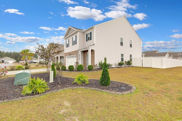 view of front of house featuring a front yard and a garage