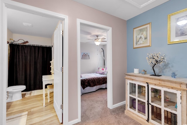 hallway featuring light colored carpet