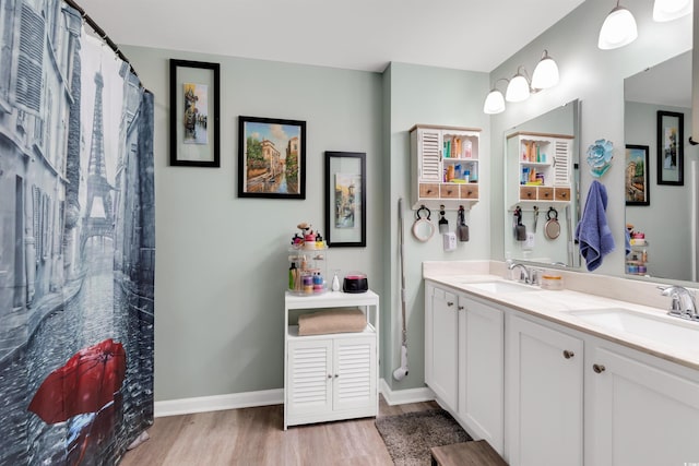 bathroom featuring a shower with shower curtain, hardwood / wood-style floors, and vanity