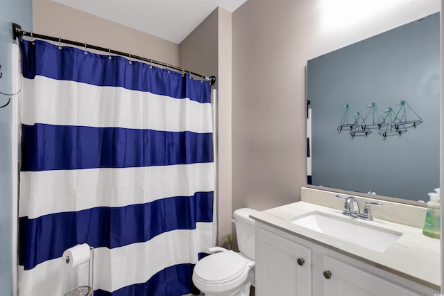 bathroom featuring vanity, toilet, and walk in shower