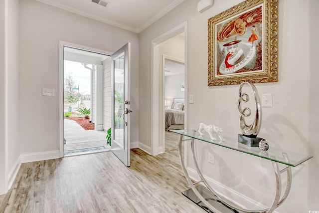 entryway featuring light hardwood / wood-style floors and ornamental molding