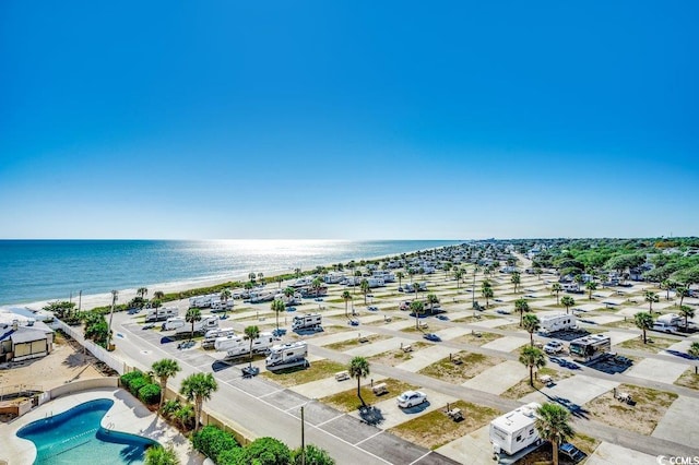 drone / aerial view featuring a water view and a beach view