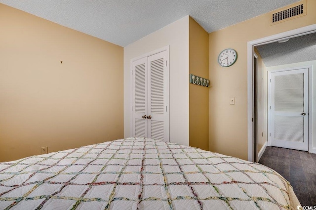 unfurnished bedroom featuring a closet, wood-type flooring, and a textured ceiling