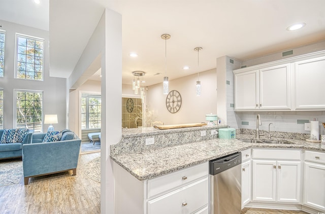 kitchen featuring dishwasher, white cabinetry, a healthy amount of sunlight, and sink