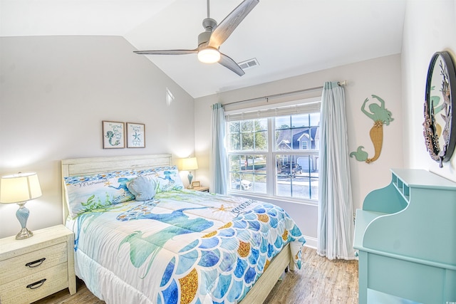 bedroom featuring ceiling fan, wood-type flooring, and vaulted ceiling