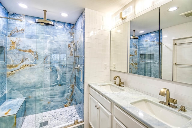 bathroom featuring vanity, an enclosed shower, and tile walls