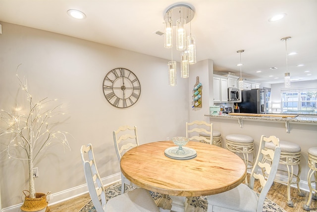 dining area featuring light wood-type flooring